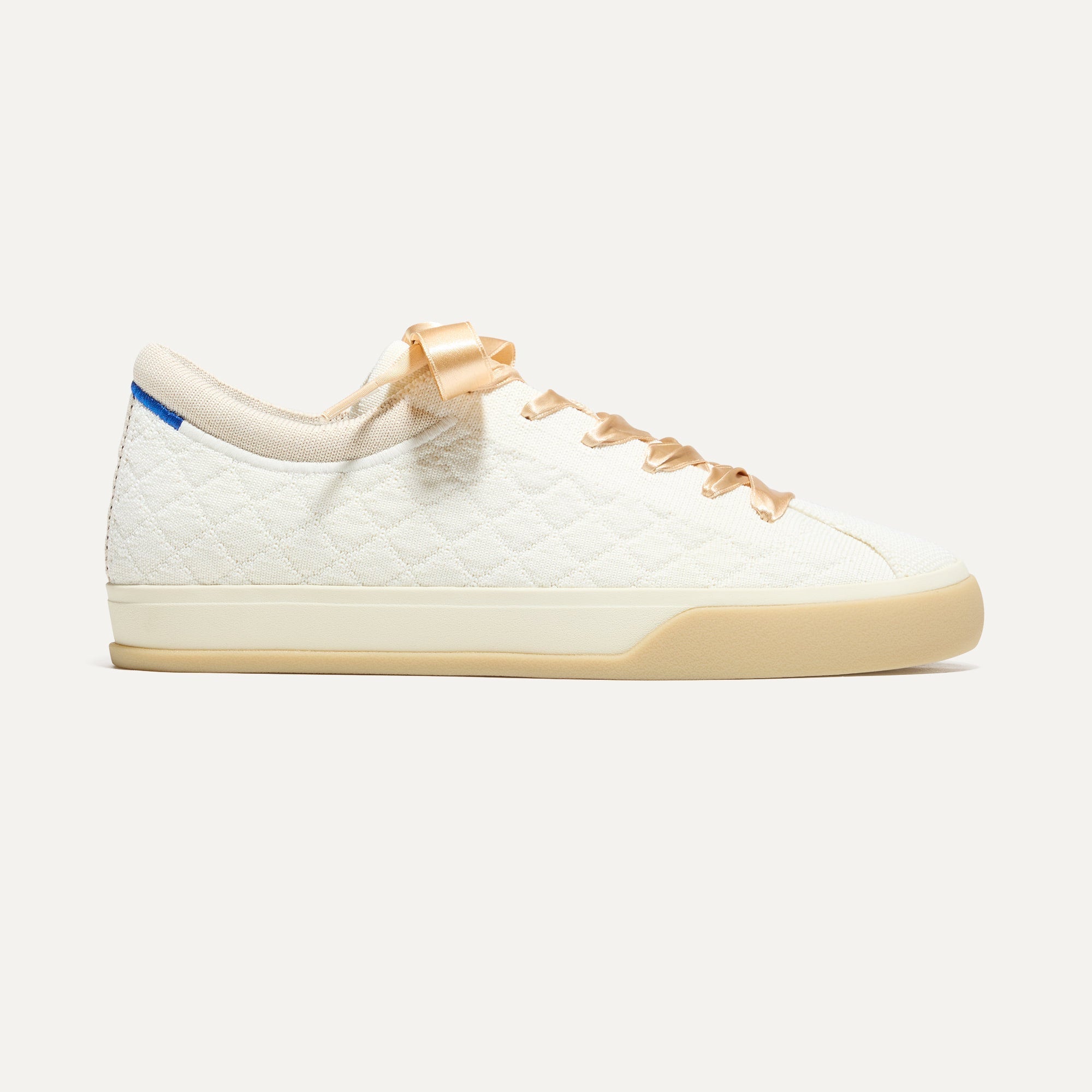 The Lace Up Sneaker in Quilted Cloud shown from the side. 
