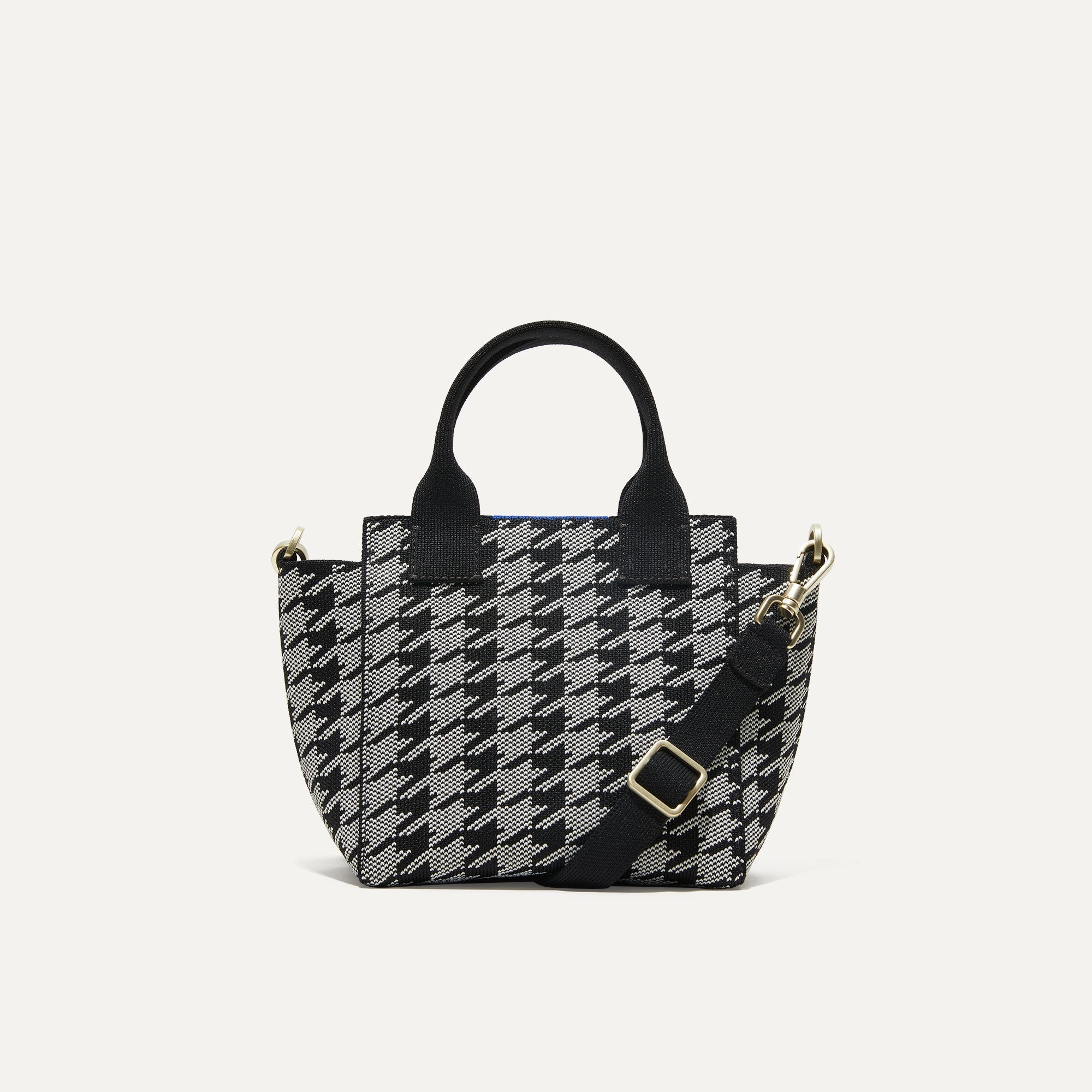 PLP |The Mini Handbag in Grey Houndstooth shown from the front.