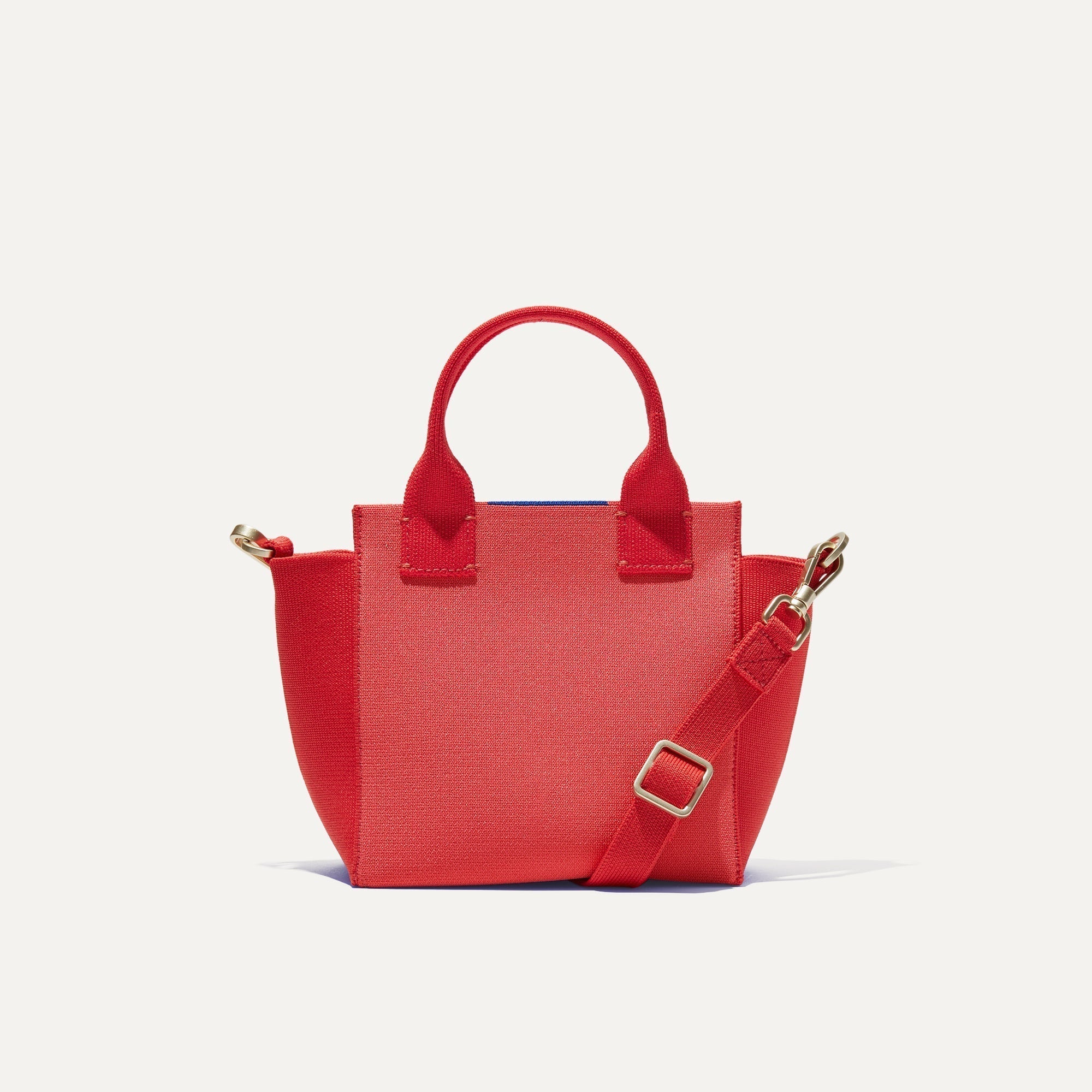 PLP |The Mini Handbag in Ruby Grapefruit shown from the front.