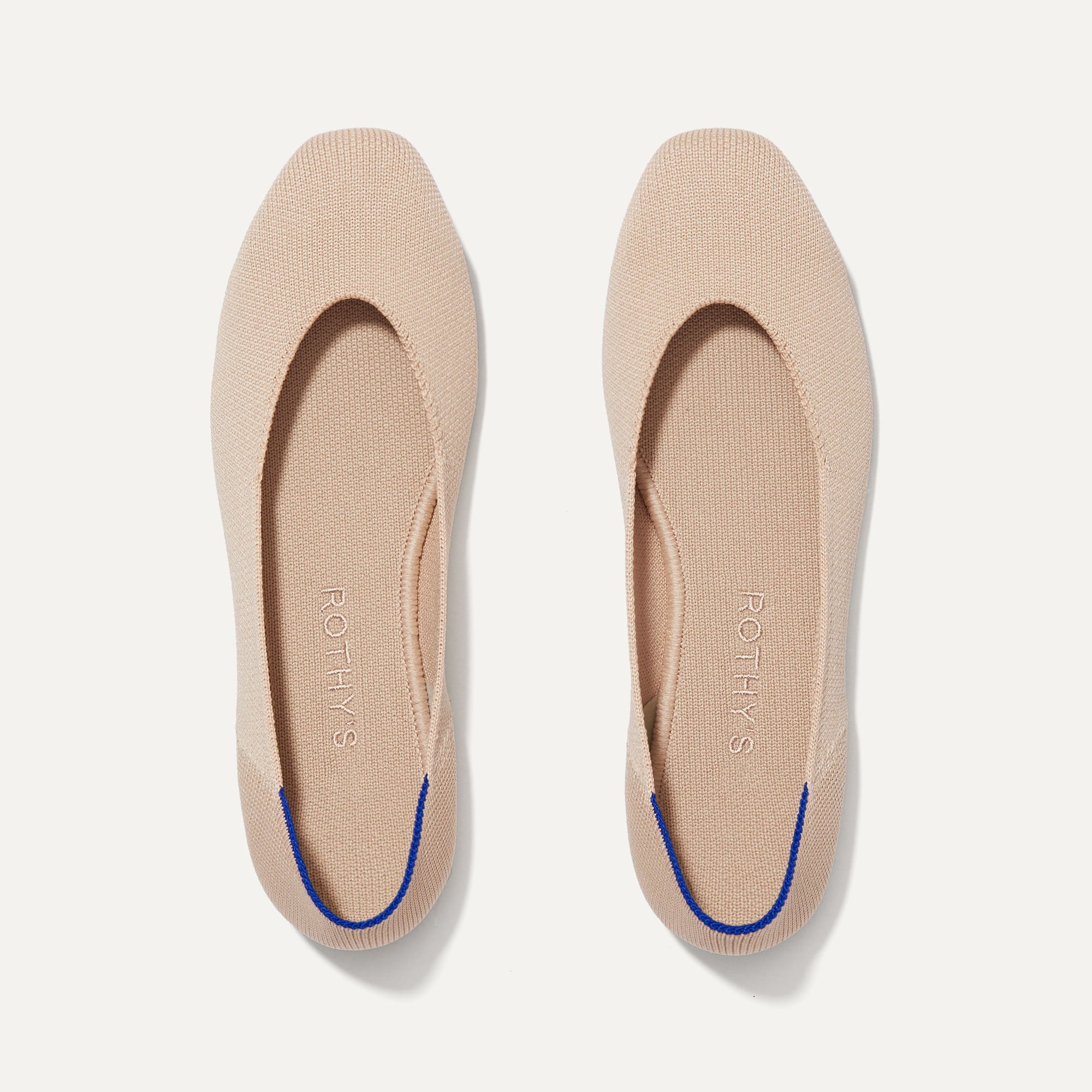 A pair of The Square toe flat shoe in Ecru shown from the top view.