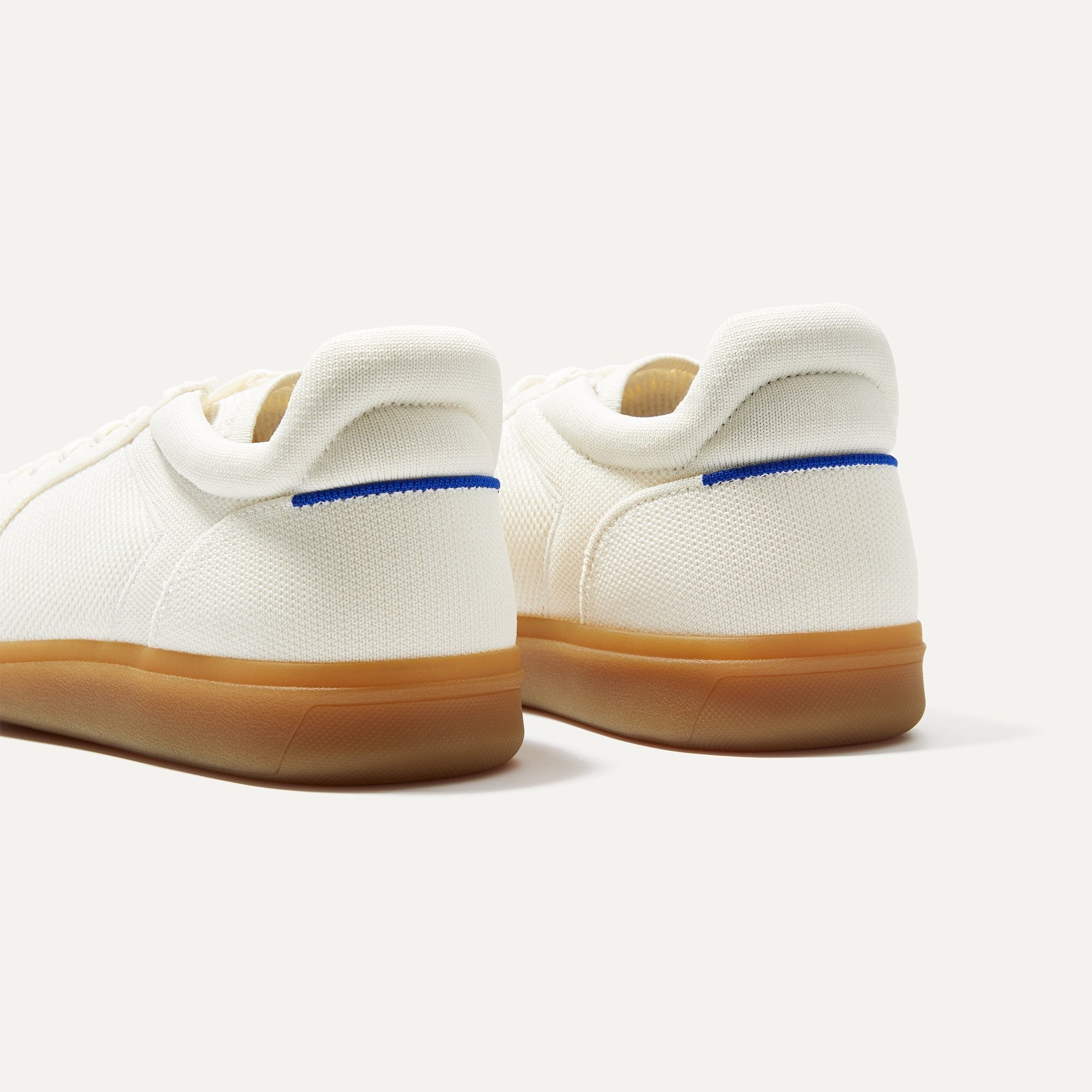 Close up of the heel of The RS01 Sneaker in Bone, with the padded ankle collar and Rothy's signature blue halo.