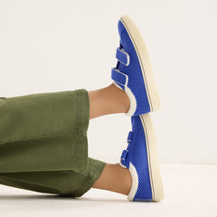 hover | A child modeling The Kids Strap Sneaker in Buoy Open-Knit. 
