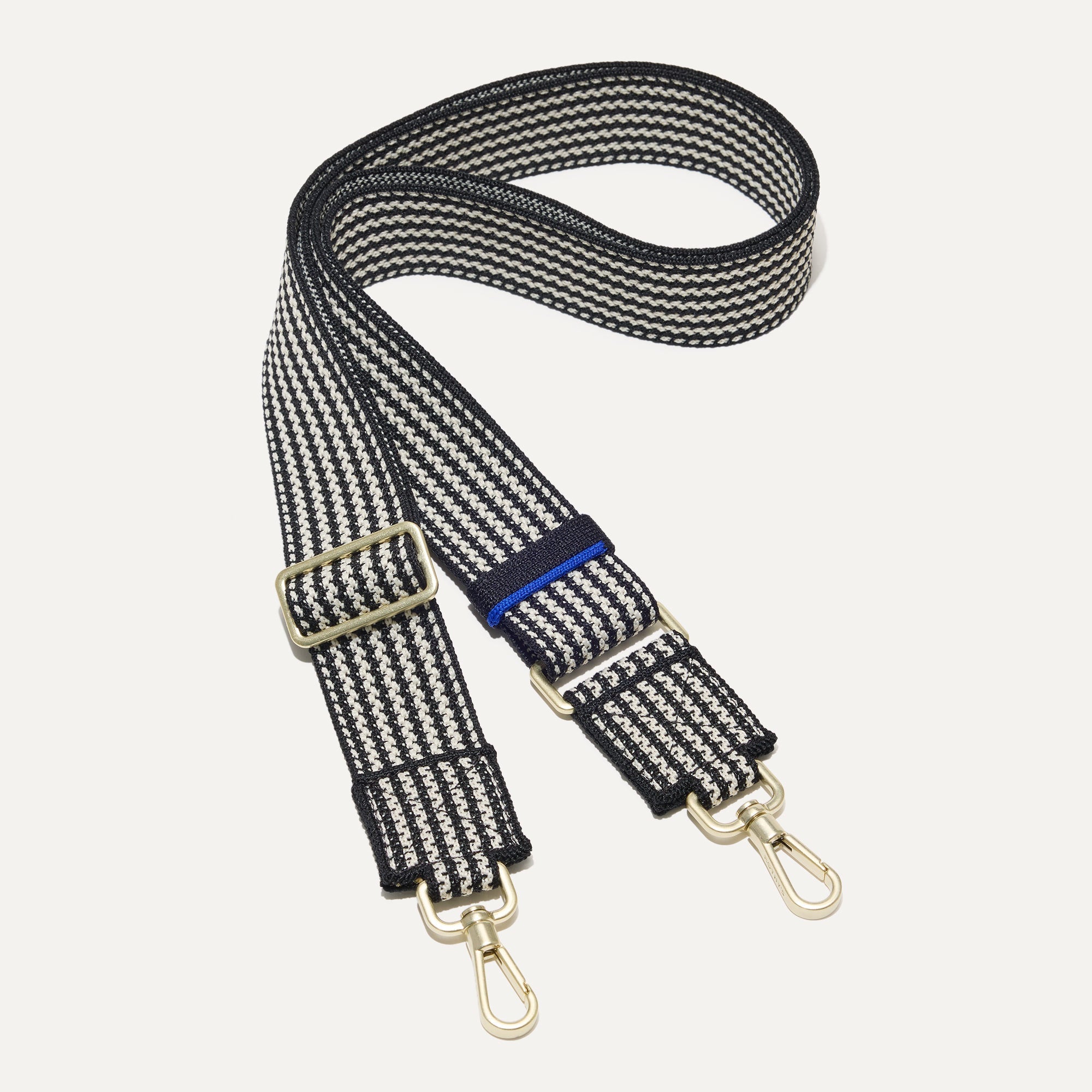 The Crossbody Strap in Salt and Pepper.