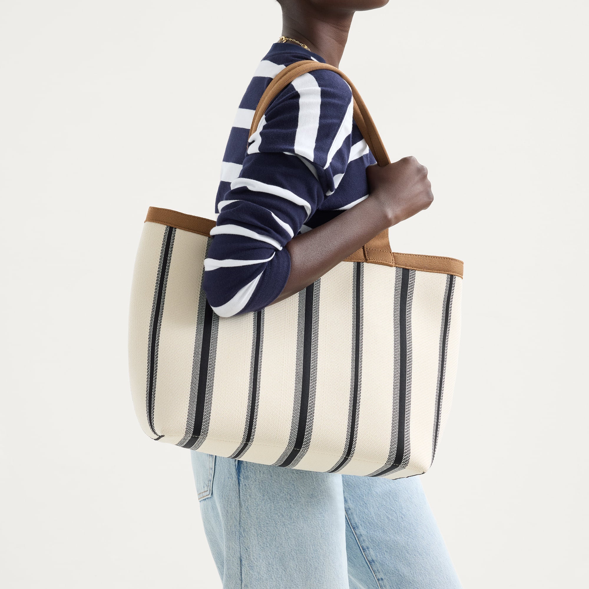 hover | Model holding The Lightweight Zip Tote in Coastline.