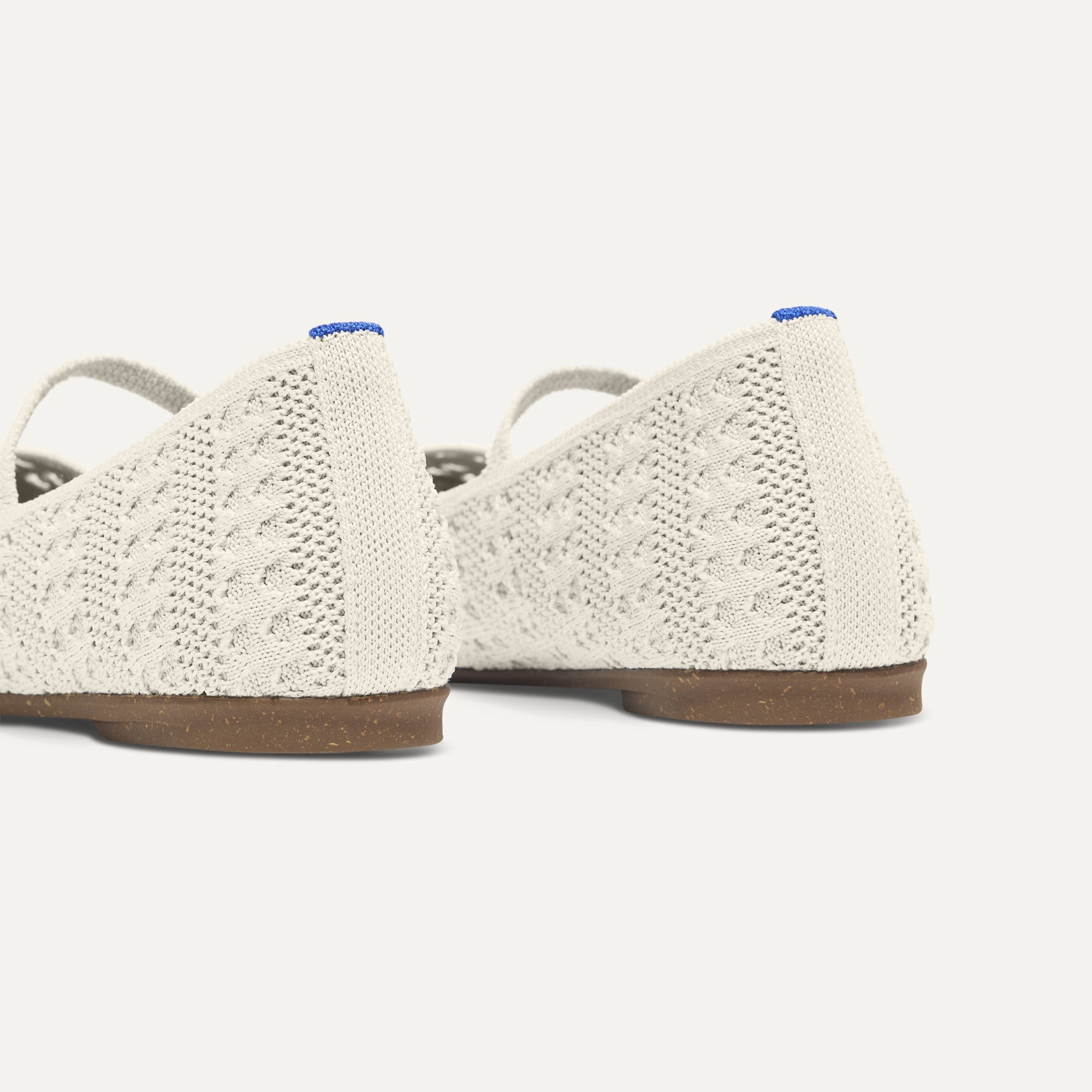 Close up of the heel of The Max Square Mary Jane in Sandy Crochet, with Rothy's signature blue halo.