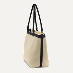 The Lightweight Zip Tote in Black and White Raffia-Knit, shown from the side.