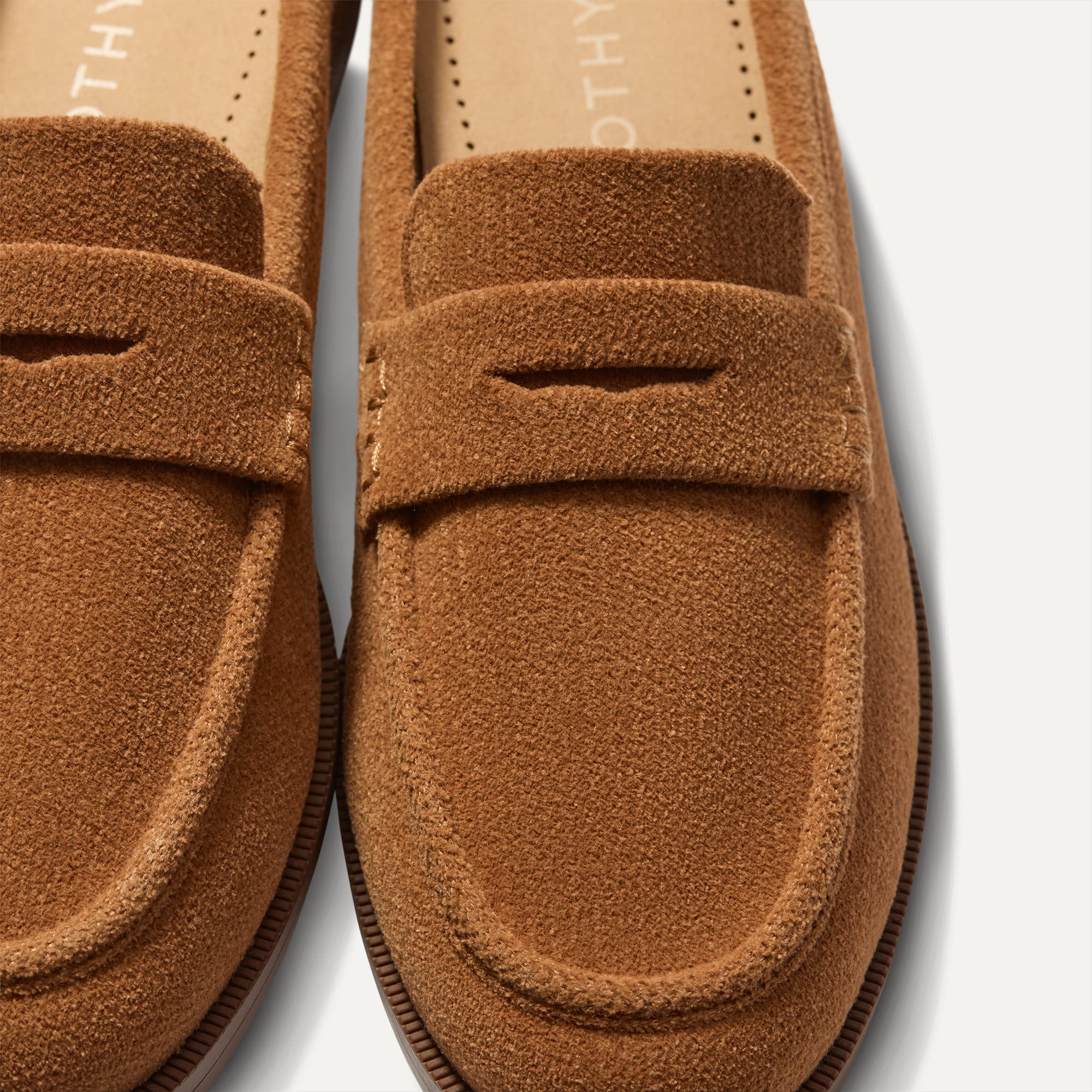 Close up of the toe and vamp of The Penny Loafer Mule in ReVelvet Caramel, showing the penny keeper detail.