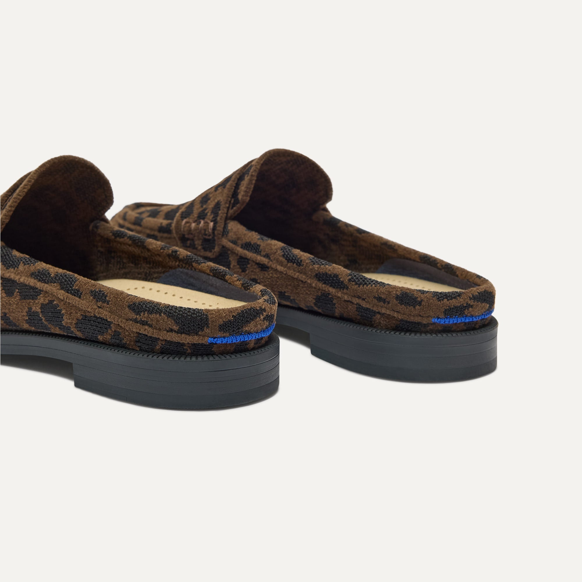 Close up of the heel of The Penny Loafer Mule in ReVelvet Cheetah, with Rothy's signature blue halo.