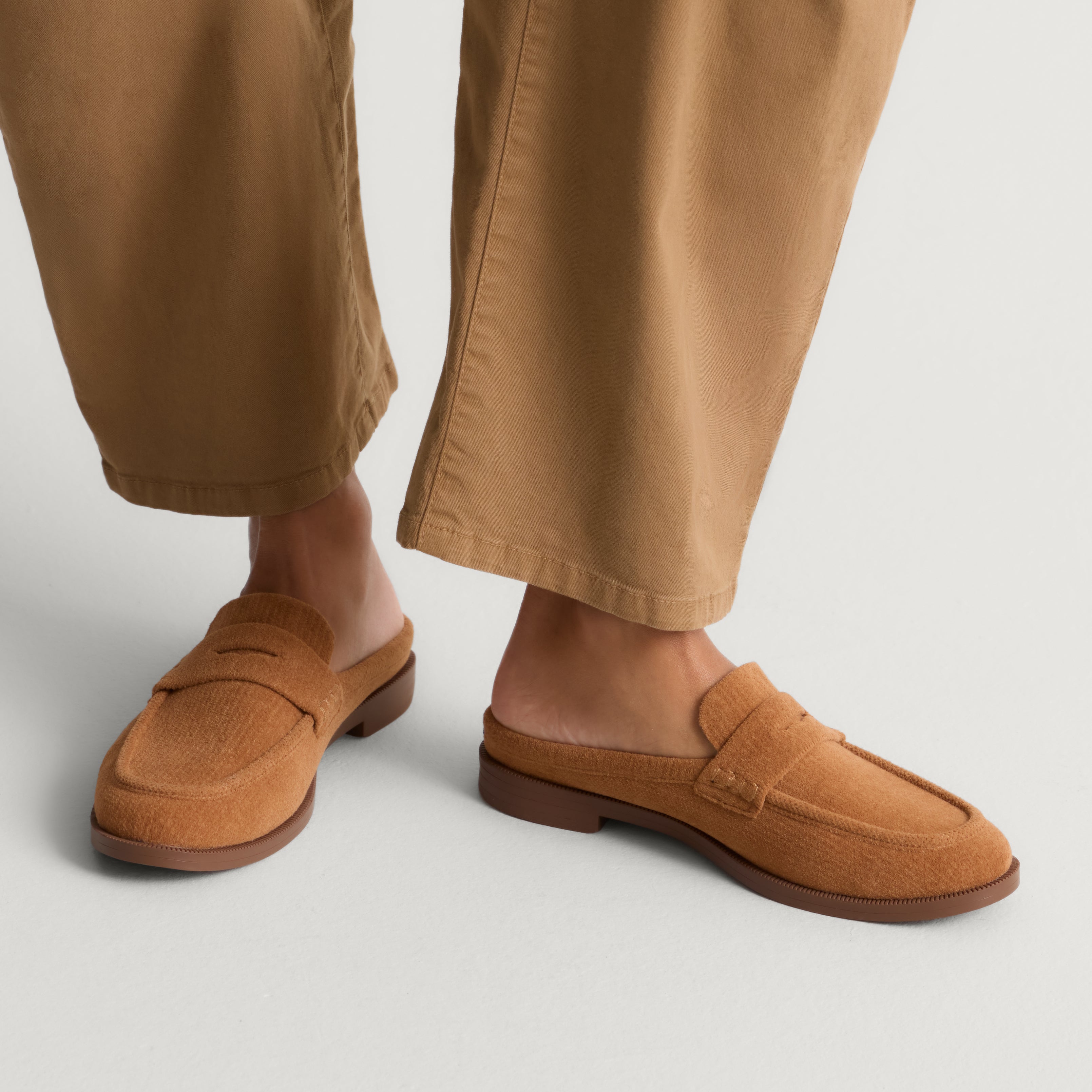 hover | Model wearing The Penny Loafer Mule in ReVelvet Caramel.