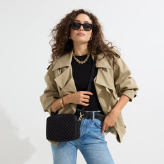 hover | The Crossbody Camera Bag in  Black Sand worn as a crossbody by a model.