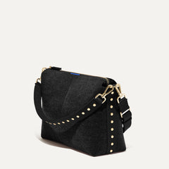 The Daily Crossbody in Revelvet™ Black shown at a diagonal view from the left.