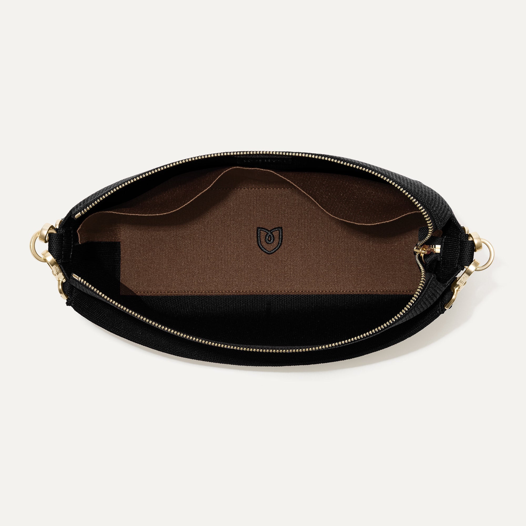 The Daily Crossbody in Revelvet™ Black shown from the top down, with zipper open and interior exposed.