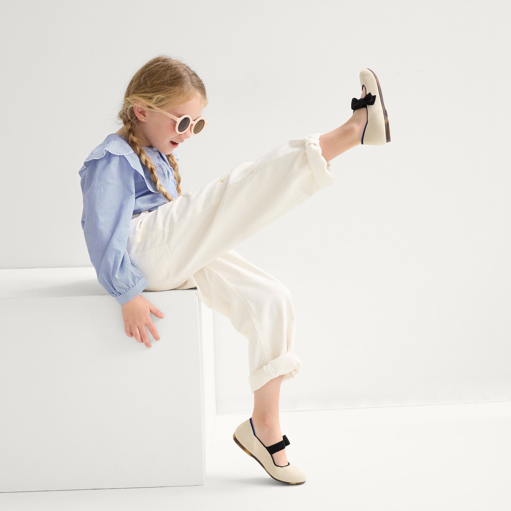 model | Alternate view of a model wearing The Kids Tux Bow Mary Jane in Ivory.