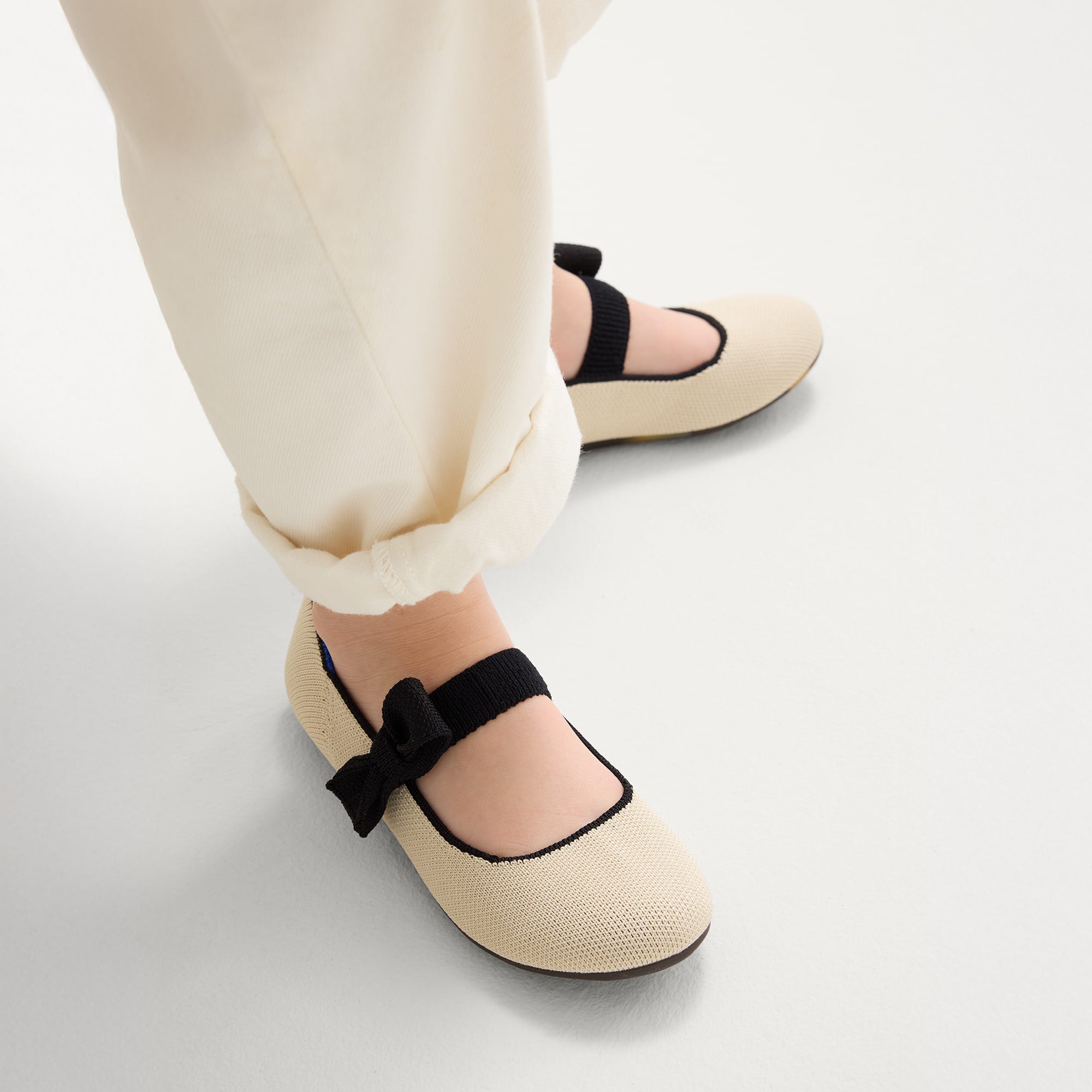 hover | Model wearing The Kids Tux Bow Mary Jane in Ivory.