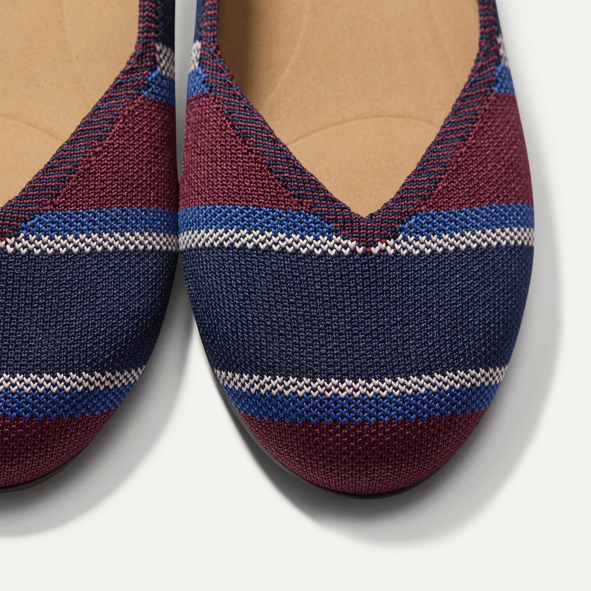 Close up of the toe and vamp of The Daily Flat in Fig Stripe. 