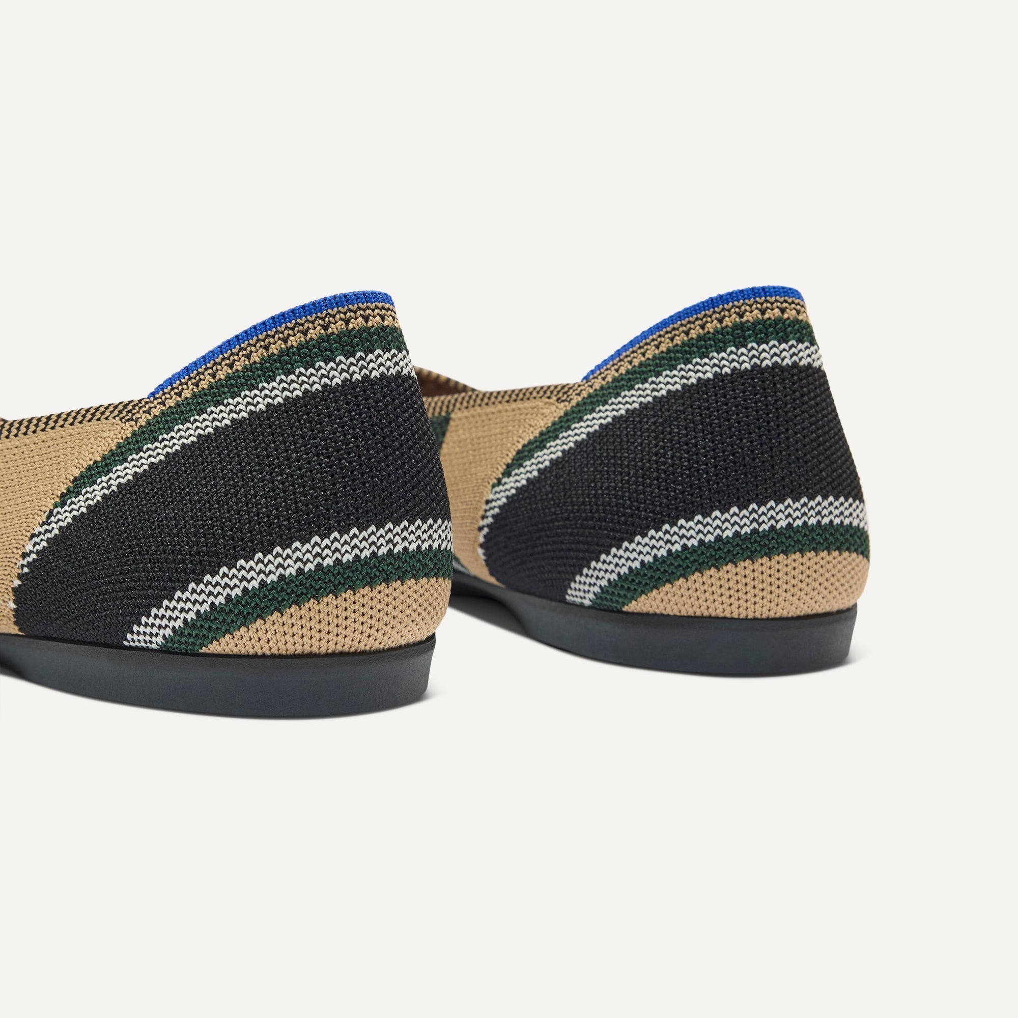 Close up of the heel of The Daily Flat in Hickory Stripe, with Rothy's signature blue halo. 