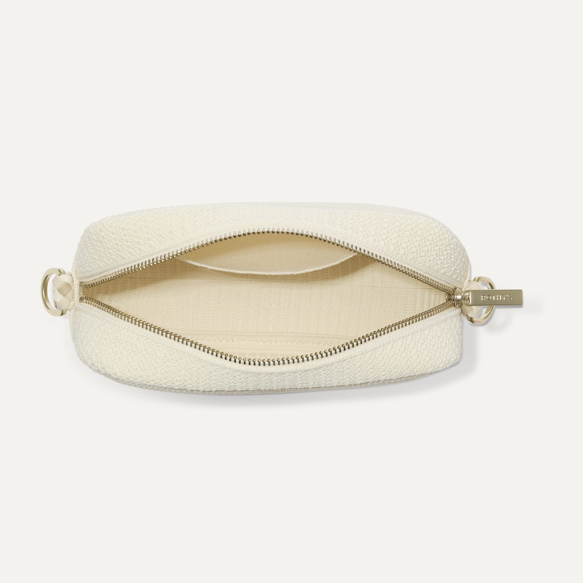 The Crossbody Camera Bag in Cream Twist Open-Knit, shown from above, with the interior exposed.