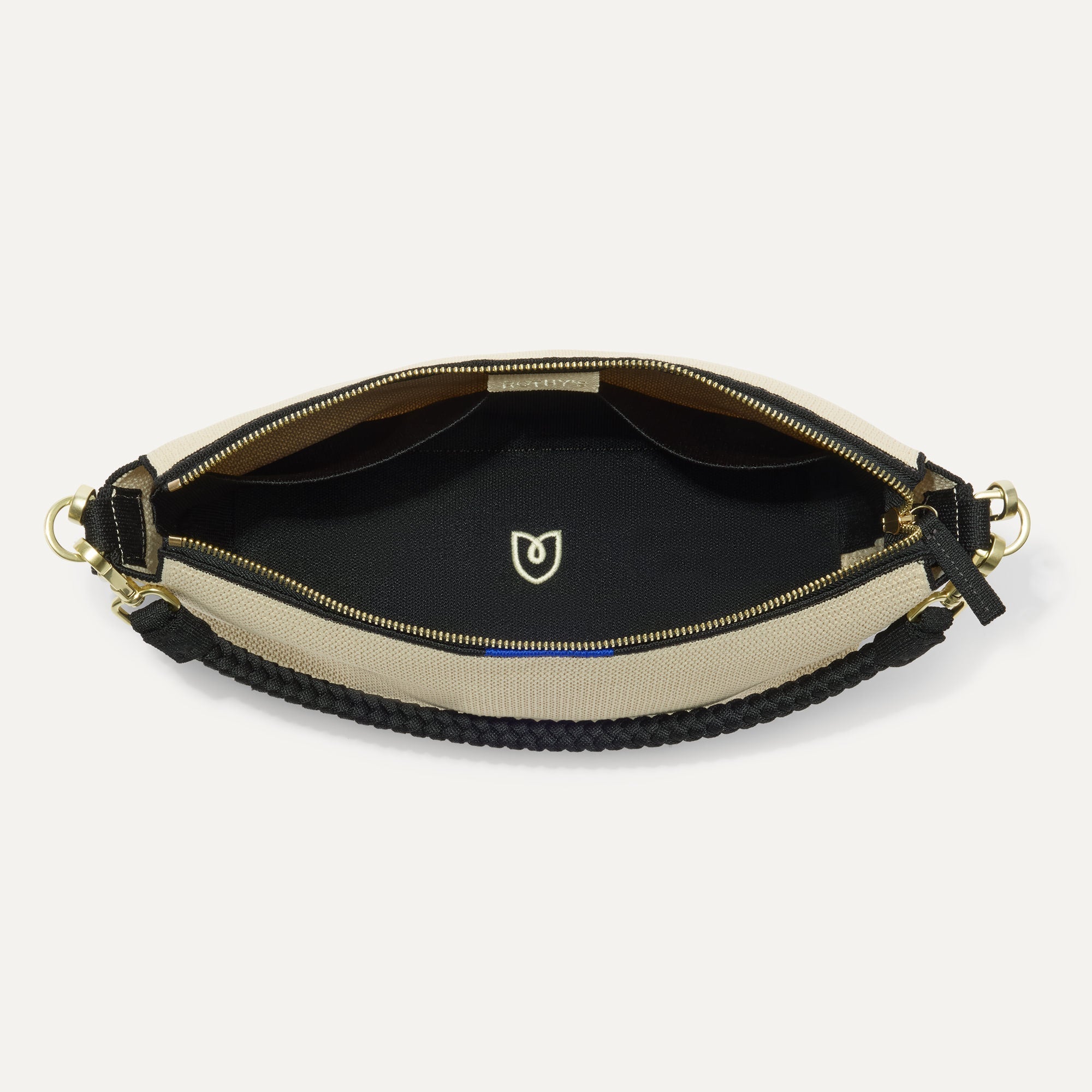 The Daily Crossbody in Black and White Raffia-Knit,  shown from the top down, with zipper open and interior exposed.