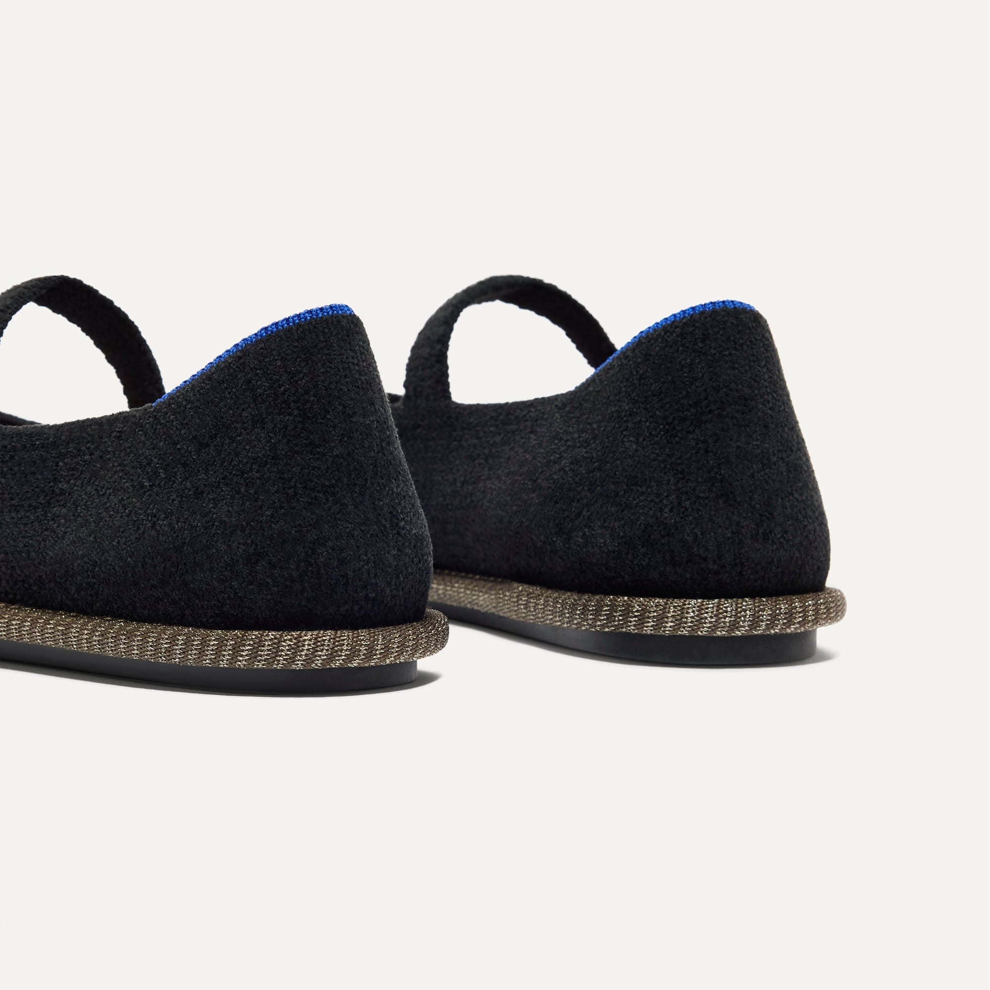 Close up of the heel of The Cruiser Mary Jane in ReVelvet Black, with Rothy's signature blue halo. 