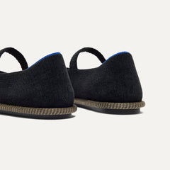 Close up of the heel of The Cruiser Mary Jane in ReVelvet Black, with Rothy's signature blue halo. 