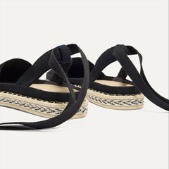 Close up of the heel of The D'Orsay Espadrille in Black, showing removable ankle straps.