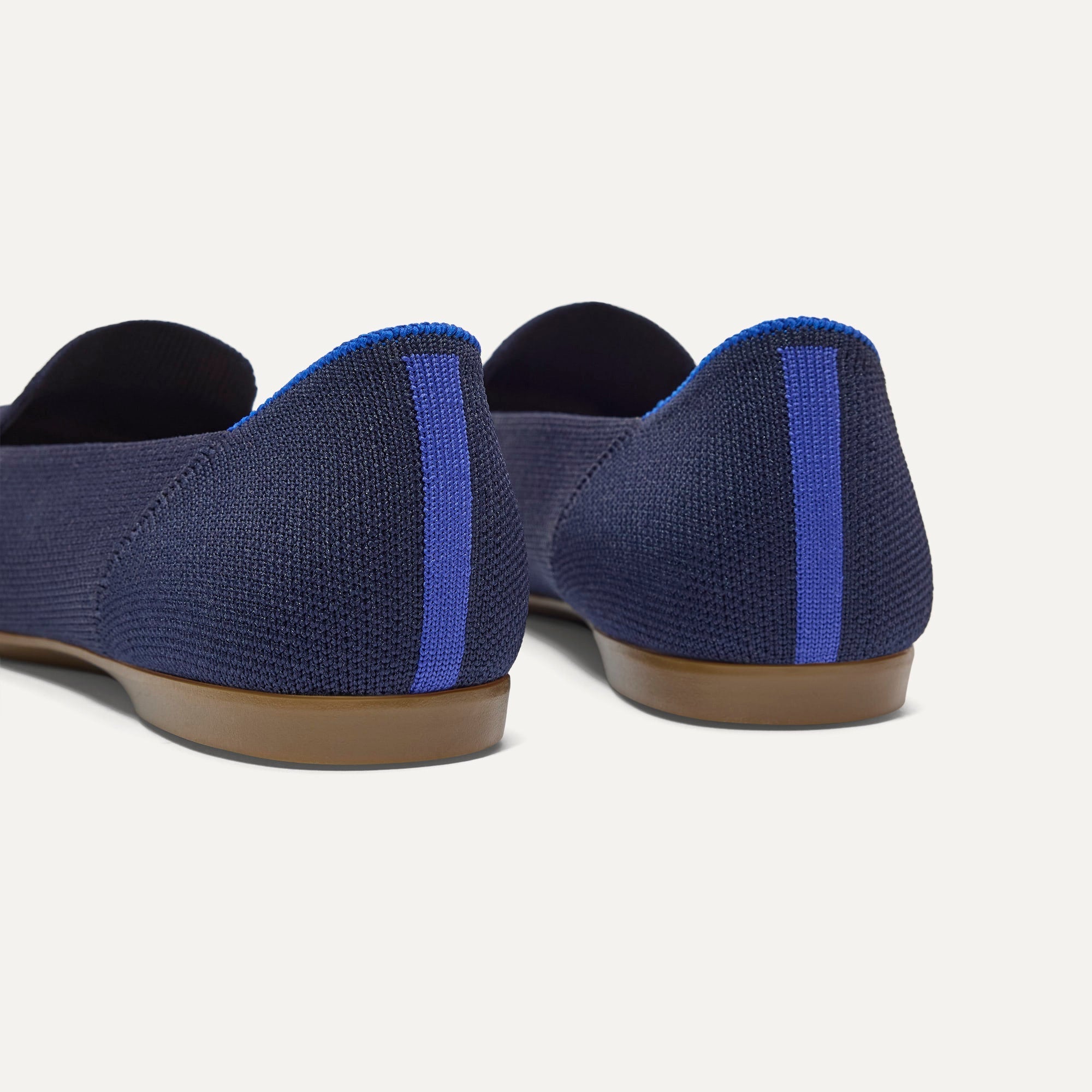Close up of the heel of The Daily Loafer in Navy, with Rothy's signature blue halo. 