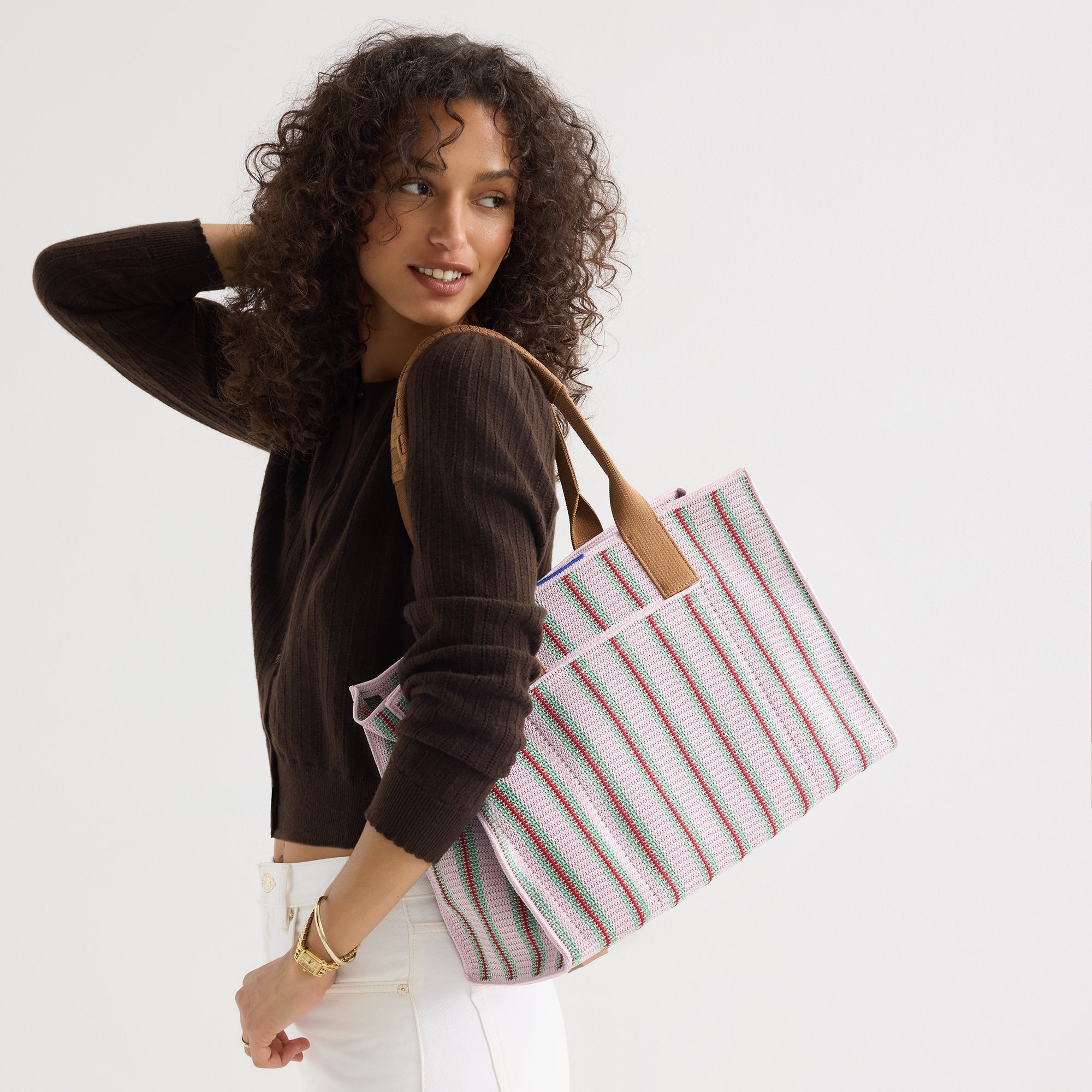 hover | The Classic Tote in Watermelon Market Stripe, worn over the shoulder by a model, shown from the side.
