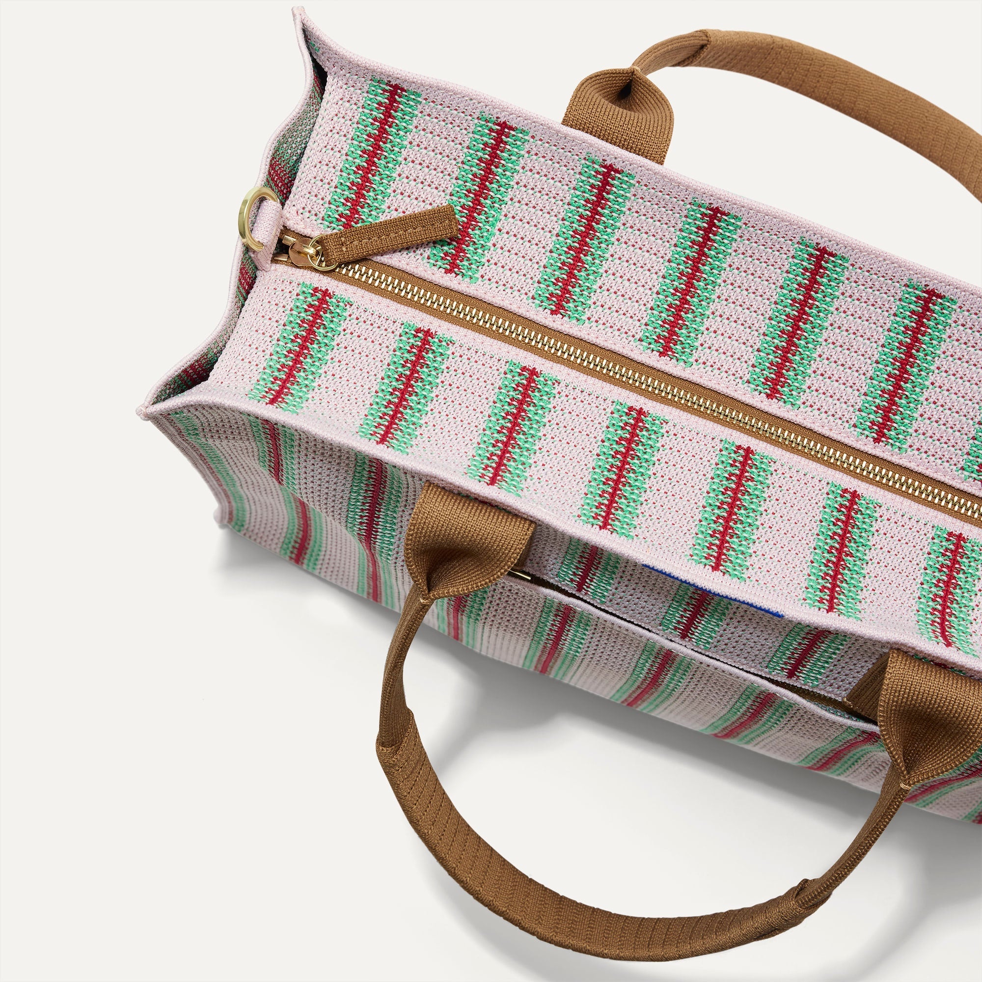 The Classic Tote in Watermelon Market Stripe, shown from above, with the top zipper closed. 