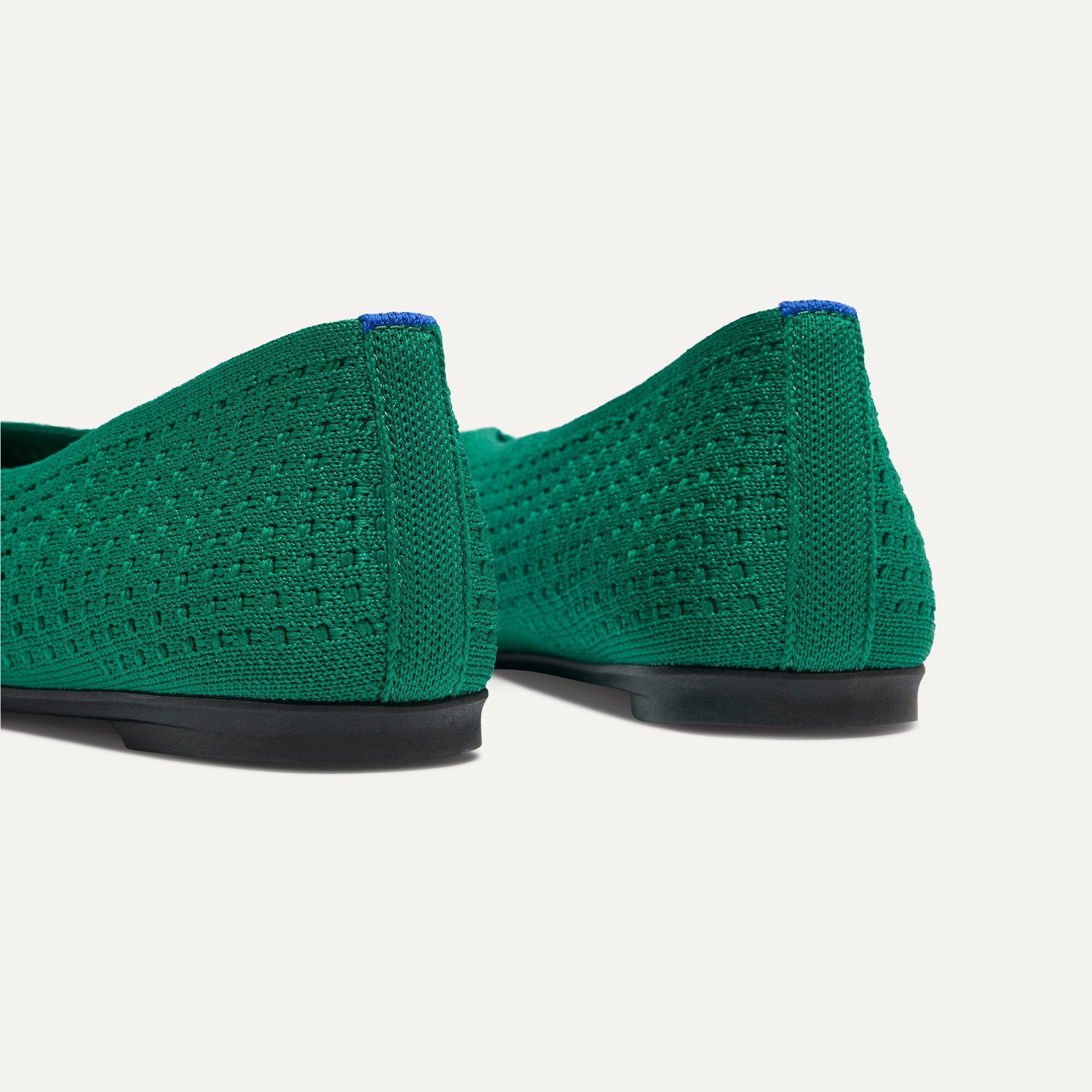 Close up of the heel of The Max Square Ballerina in Clover Mesh with Rothy's signature blue halo.