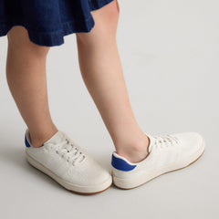 hover | A child modeling The Kids Stretch Sneaker in Turbo.