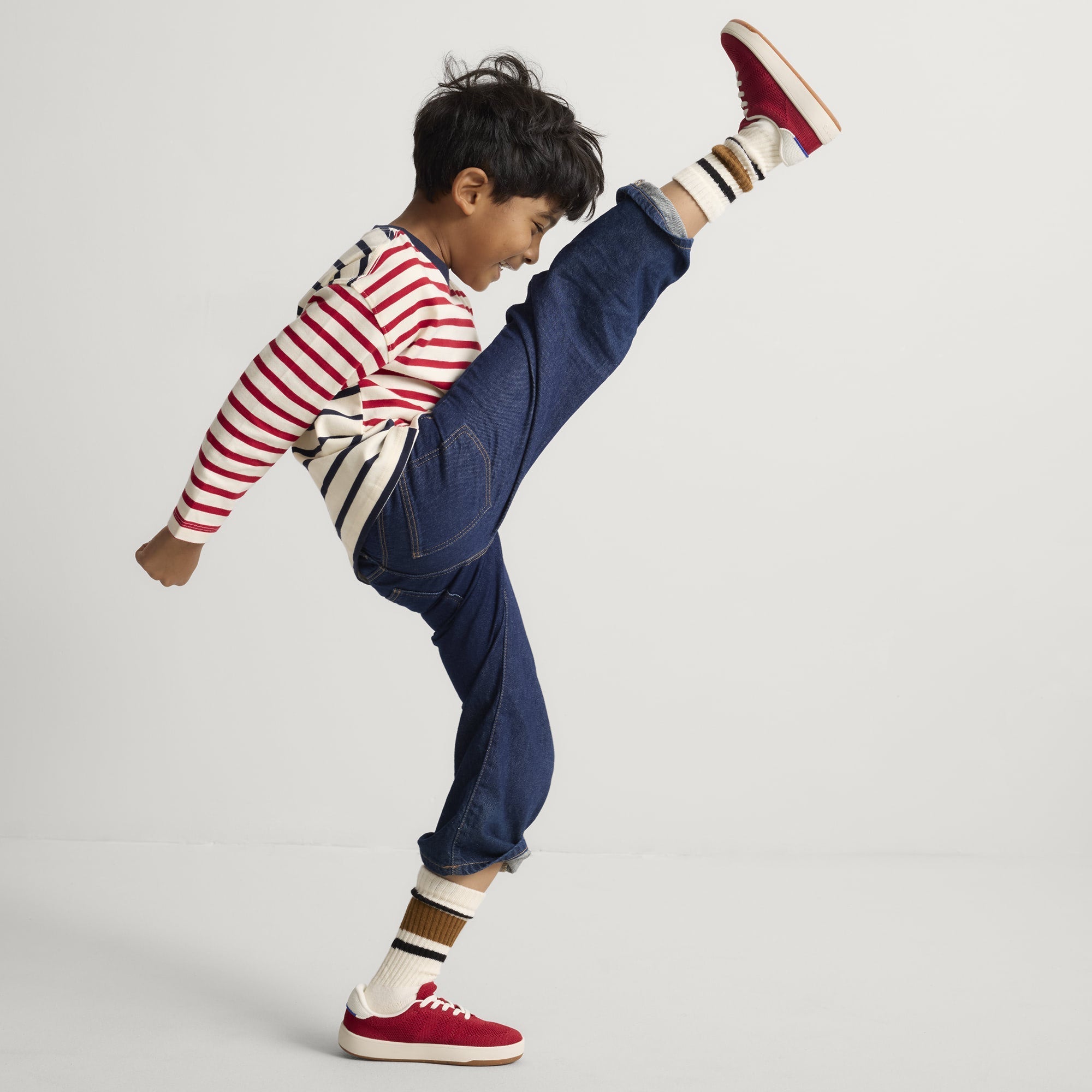 model | Alternate image of a child modeling The Kids Stretch Sneaker in Firecracker.