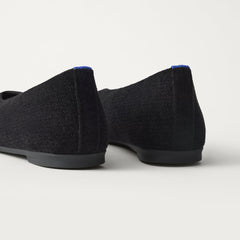 Close up of the heel of The Max Square Ballerina in ReVelvet Black with Rothy's signature blue halo.