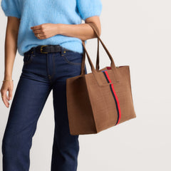 hover | The Classic Tote in ReVelvet Cinnamon Stripe, worn over the shoulder by a model, shown from the side.