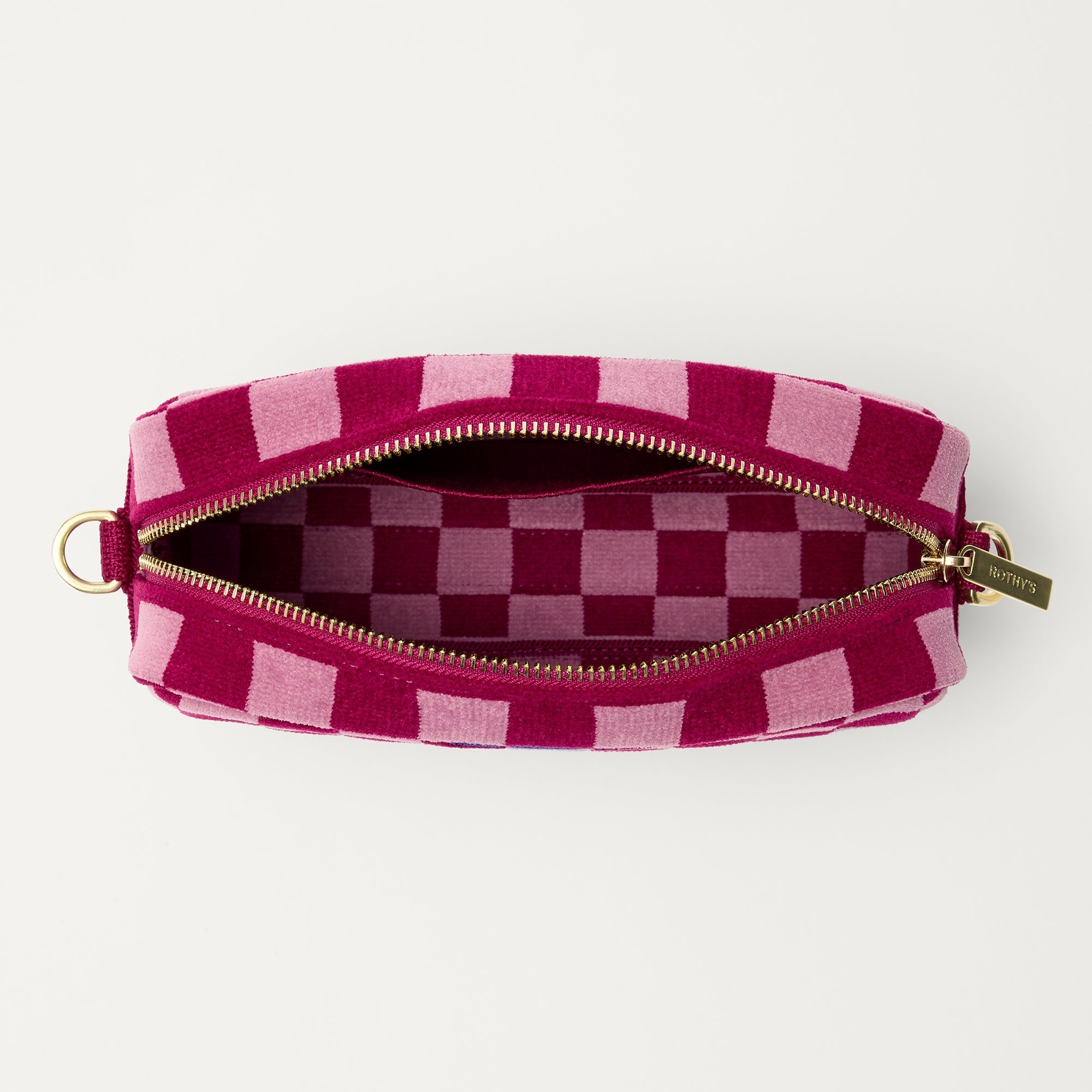 The Crossbody Camera Bag in ReVelvet™ Orchid, shown from above, with the interior exposed.