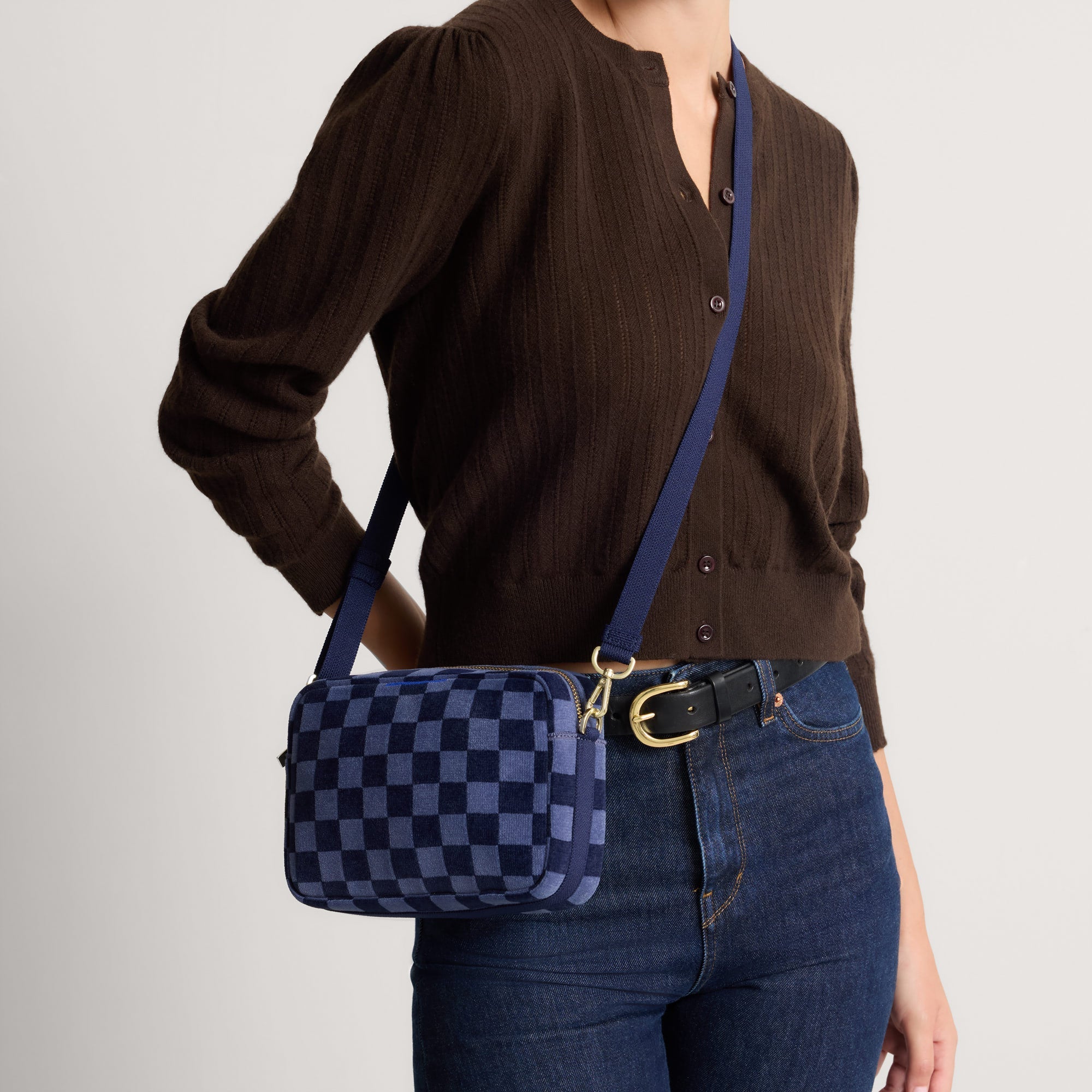 hover | Model wearing The Crossbody Camera Bag in  ReVelvet™ Blue Ink, shown from the front. 