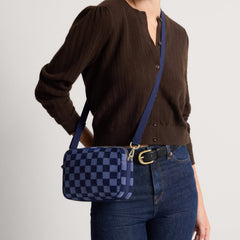 hover | Model wearing The Crossbody Camera Bag in  ReVelvet™ Blue Ink, shown from the front. 